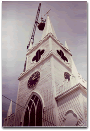 Belden Morse, Steeple Renovation Consultant, replaces the arrow on the steeple of the East Machias Congregational Church